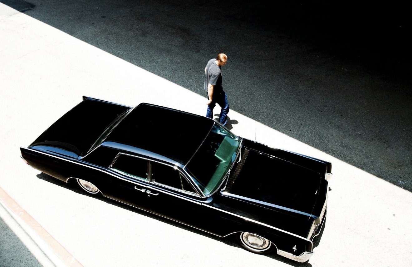 Bodie beside a classic car — overhead view