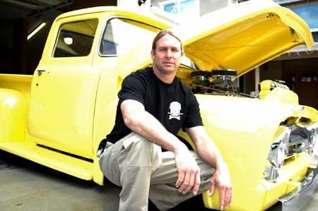 Bodie beside a yellow custom pickup